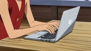 Luffy programming on a Macbook in the Thousand Sunny